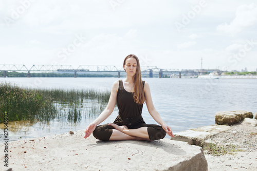 Young attractive woman doing dancers yoga pose outdoor