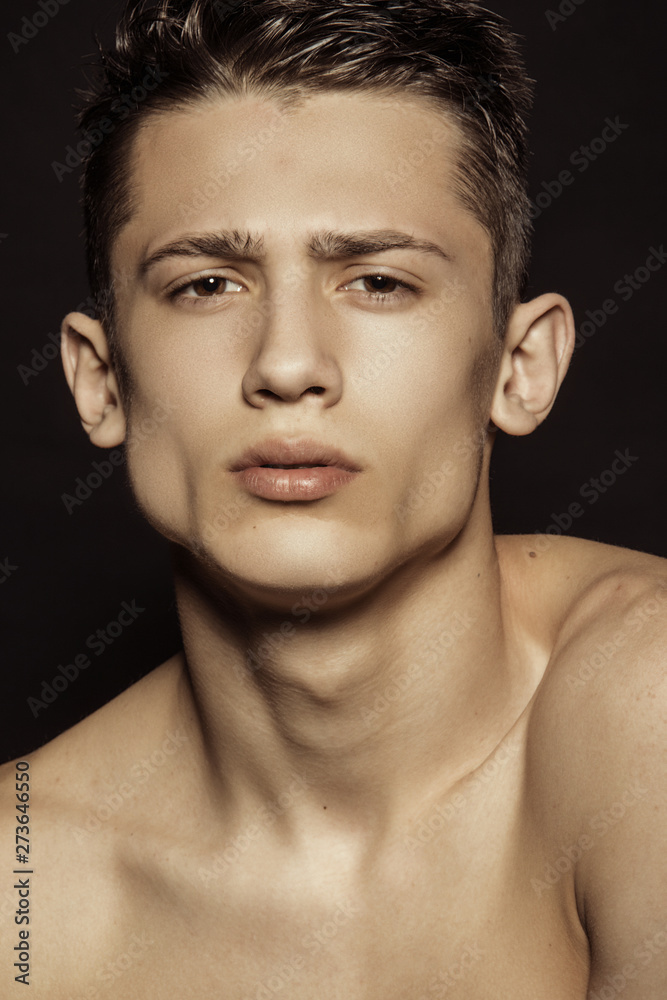 Muscle strong beautiful stripped male model portrait on black isolated font background