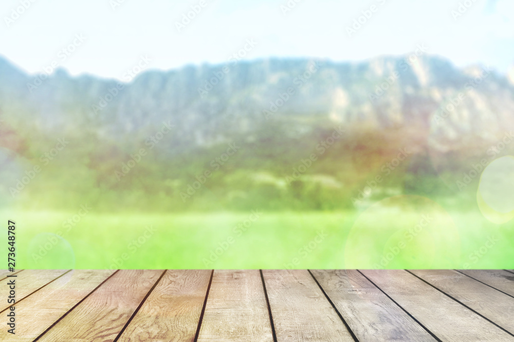 Table top with background mountains, sky and cloud in sunny day for product display job showing. Wooden table on blurred abstract background for display or montage your products. Table top with background mountains, sky and cloud in sunny day for product display job showing. Wooden table on blurred abstract background for display or montage your products.