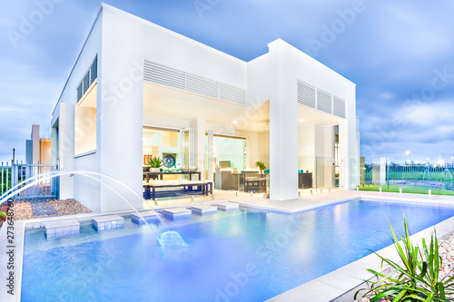 Swimming pool with natural look at home front. © JRstock
