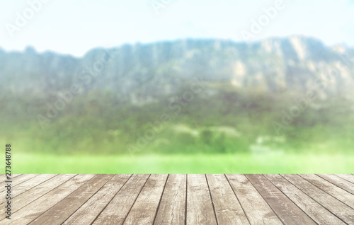 Table top with background mountains, sky and cloud in sunny day for product display job showing. Wooden table on blurred abstract background for display or montage your products.