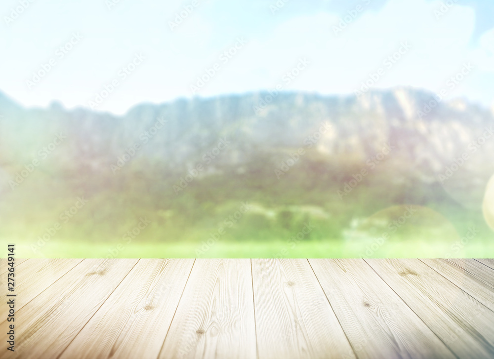 Wood table top on blur mountains background. Nature concept of landscape. Empty brown wooden table on natural background for montage product display or design key visual layout. Wood table top on blur mountains background. Nature concept of landscape. Empty brown wooden table on natural background for montage product display or design key visual layout.