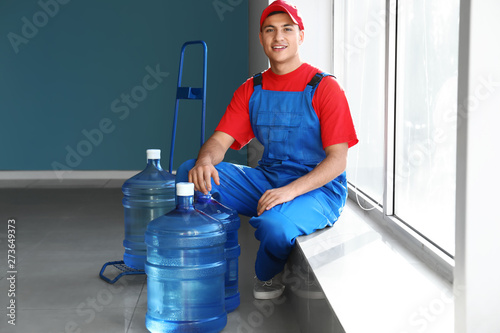 Delivery man with bottles o...