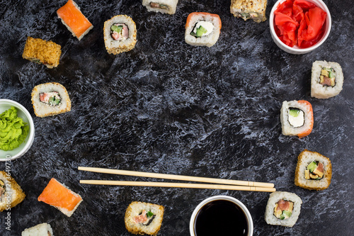 Set of sushi and maki on stone table. Top view with copy space © dashtik