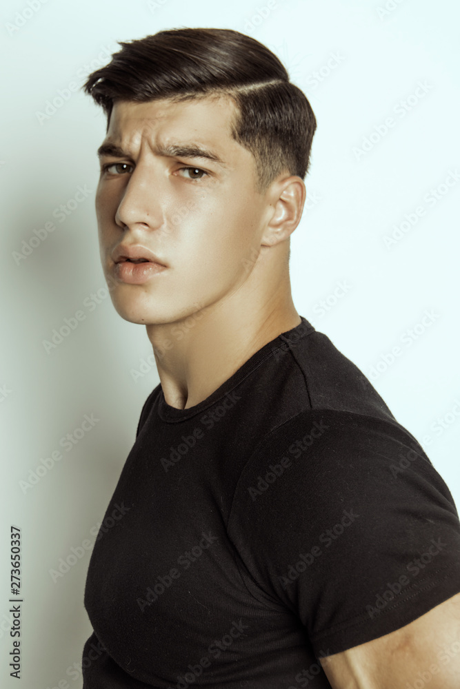 Strong stripped muscle male model in black underwear and black t-shirt on grey isolated font background Strong stripped muscle male model in black underwear and black t-shirt on grey isolated font background
