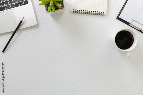 Photos Flay lay, Top view office table desk with computer laptop, coffee, pencil, leaves with copy space white background