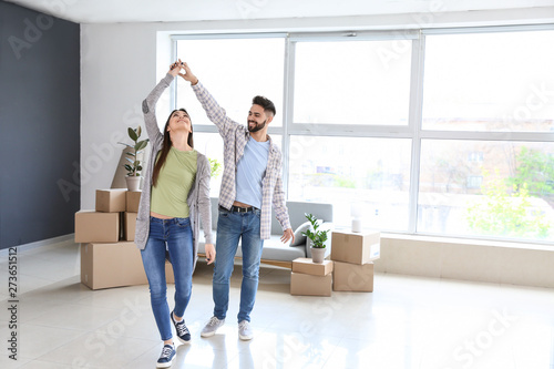Young couple dancing in their new house © Pixel-Shot