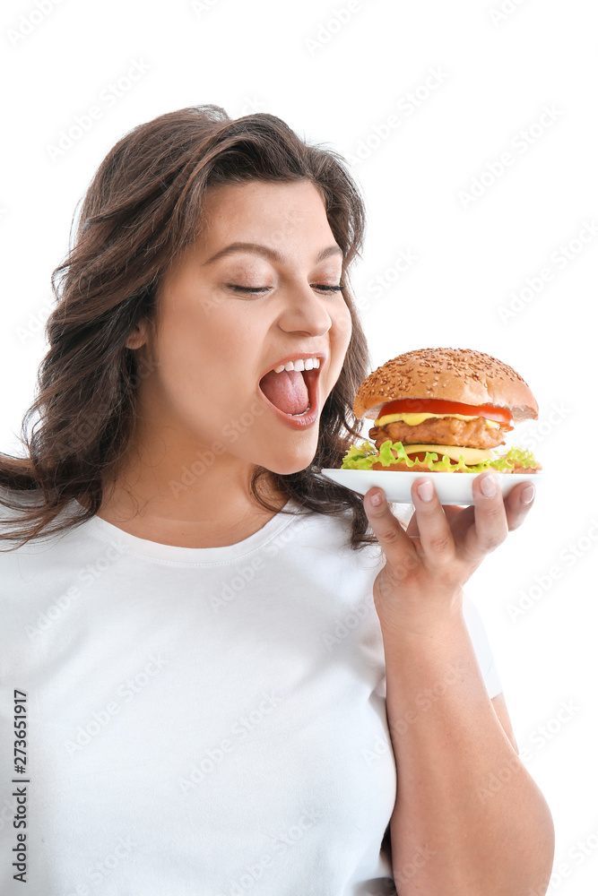 Plus size woman with tasty burger on white background. Concept of body positive Plus size woman with tasty burger on white background. Concept of body positive