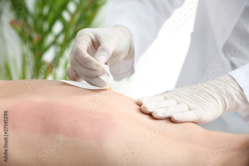 Young man during epilation ...