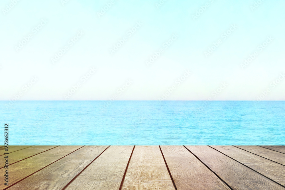 Table top with beach background, sky and cloud in sunny day for product display job showing. Wooden table for display or montage your products. Table top with beach background, sky and cloud in sunny day for product display job showing. Wooden table for display or montage your products.