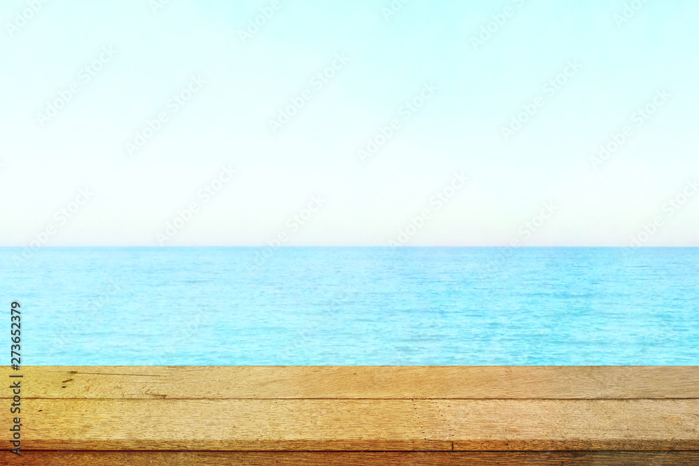 Table top with beach background, sky and cloud in sunny day for product display job showing. Wooden table for display or montage your products. Table top with beach background, sky and cloud in sunny day for product display job showing. Wooden table for display or montage your products.
