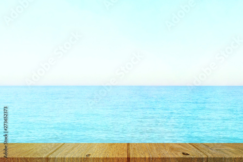 Table top with beach background  sky and cloud in sunny day for product display job showing. Wooden table for display or montage your products.