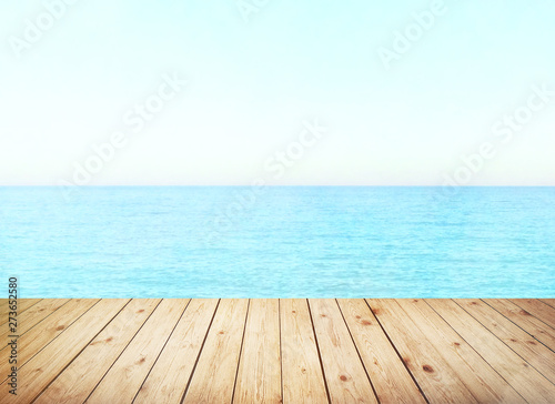 Table top with sea background, sky and cloud in sunny day for product display job showing. Wooden table for display or montage your products.