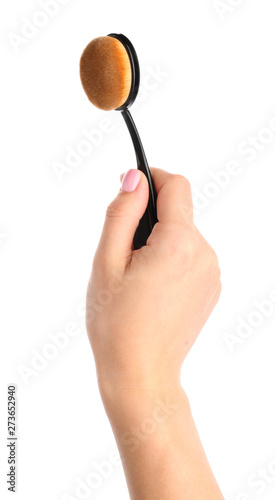 Female hand holding oval ma...