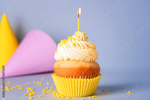 Tasty Birthday cupcake on grey background