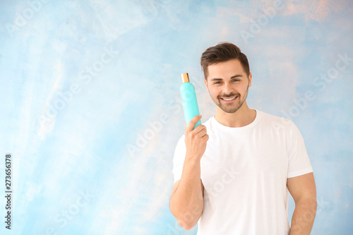 Handsome man with bottle of...