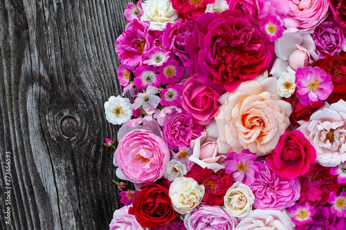 pink red  violet and white roses on wooden surface