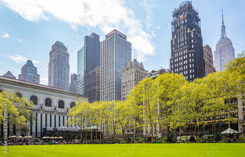 Bryant park, New York, Manhattan. High buildings view from below against blue sky background, sunny day in spring photo