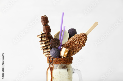 Mason jar with delicious freak shake on white background photo