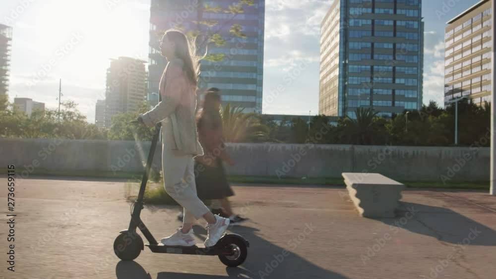 Young beautiful woman riding an electric scooter to work, modern girl, new generation, electric transport, ecology, ecological transport, sunset, electric skateboard, 4k