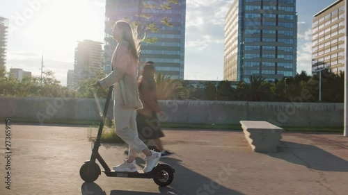 Young beautiful woman riding an electric scooter to work, modern girl, new generation, electric transport, ecology, ecological transport, sunset, electric skateboard, 4k photo