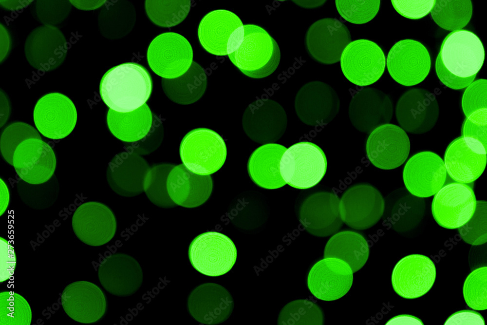 Unfocused abstract colourful bokeh black background. defocused and blurred many round green light Unfocused abstract colourful bokeh black background. defocused and blurred many round green light