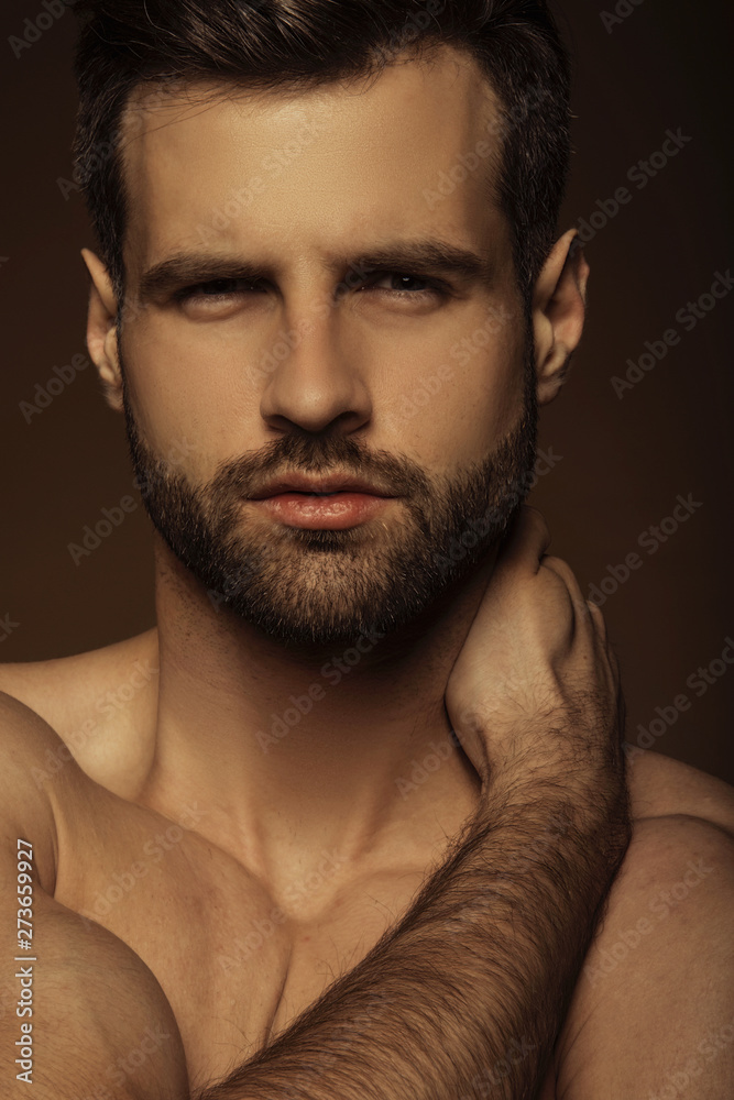 Handsome sport sexy stripped guy portrait in underwear with on isolated beige background