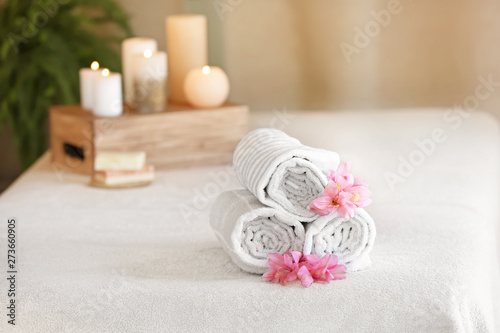 Rolled towels on massage table in spa salon