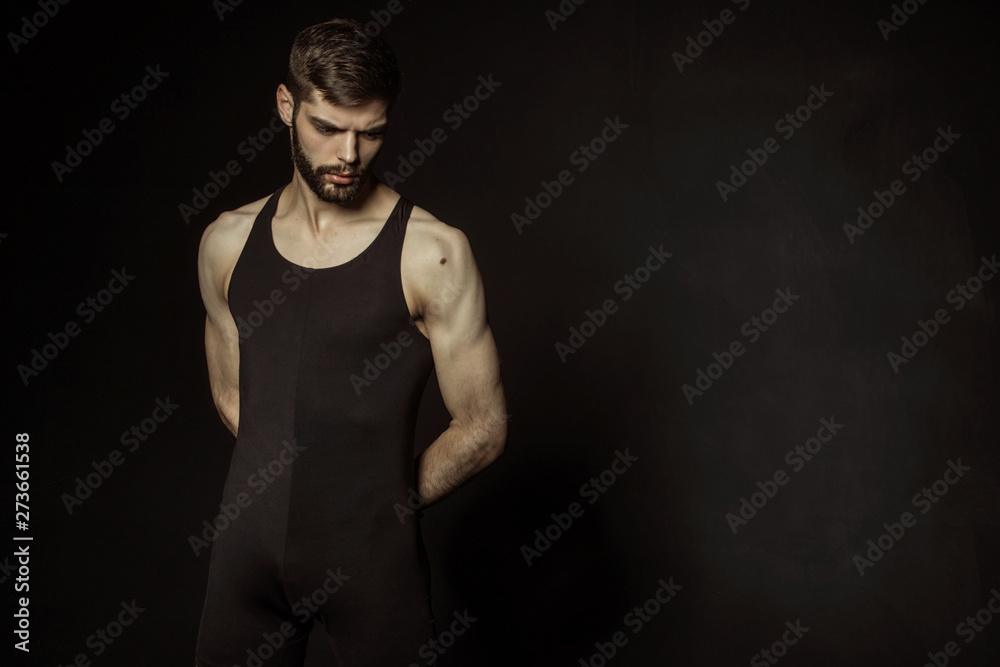 Muscle strong bearded face beautiful stripped male model in black underwear on black isolated font background Muscle strong bearded face beautiful stripped male model in black underwear on black isolated font background