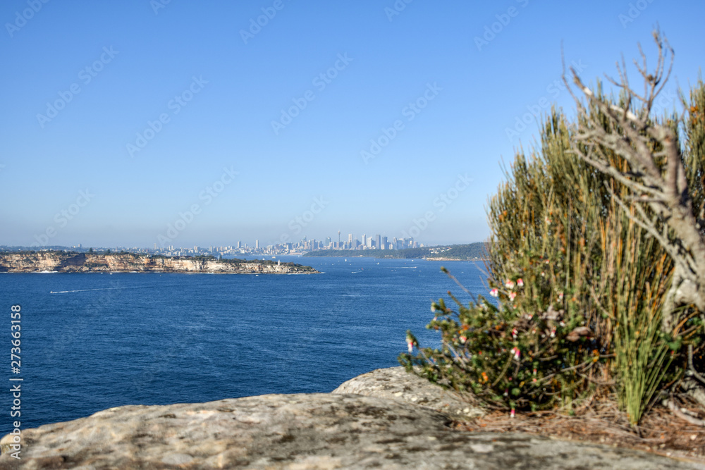 Morning view of a the Sydney city skyline seen from North Head, a headland in Manly and part of Sydney Harbour National Park in Sydney, New South Wales, Australia. South Head on the left.