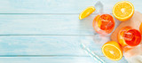 Aperol and ingredients drinks on wood background, copy space