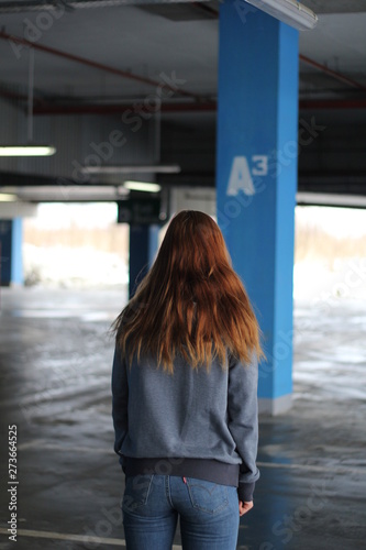 Girl with red hair in gray hoodie. Street style. Advertising brand clothing. Fashion Shooting