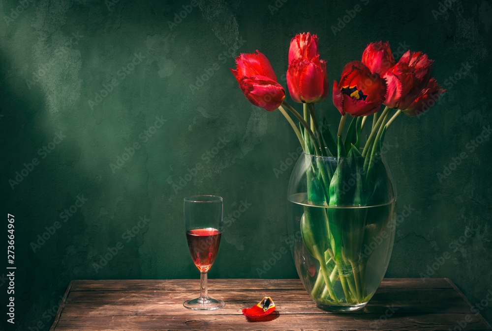 Classic still life with beautiful red tulip flowers bouquet in transparent  glass vase and a glass of red wine. Art photography. Stock Photo | Adobe  Stock