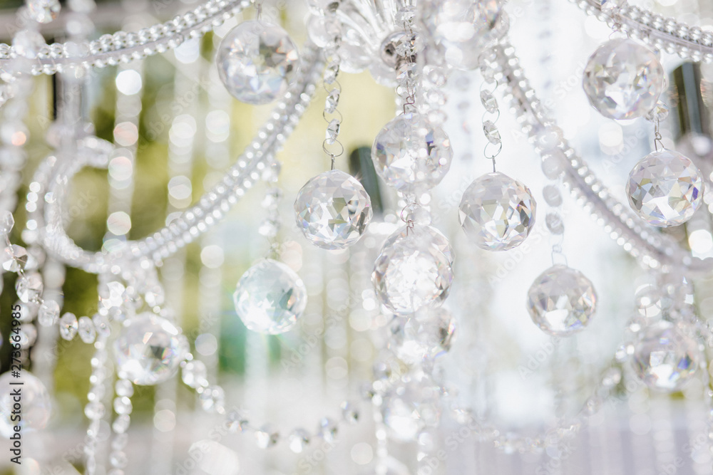 Ceremony Decoration Sparkle Crystal on Chandelier. Closeup Beautiful Brilliant Diamond Bright Detail of Interior Room for Wedding or Birthday Celebration. Object on Abstract Background