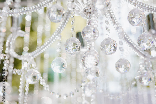 Ceremony Decoration Sparkle Crystal on Chandelier. Closeup Beautiful Brilliant Diamond Bright Detail of Interior Room for Wedding or Birthday Celebration. Object on Abstract Background