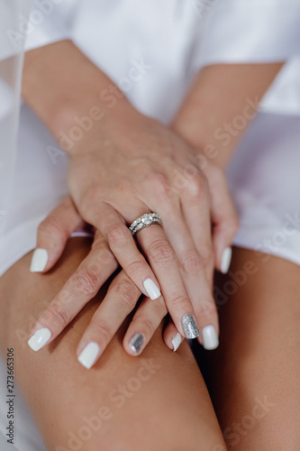 Jewelry Ring with Brilliant Diamond on Finger. Bright Platinum or White Gold Engagement Annulus on Hand of Woman Future Marriage Wife. Closeup Photo of Bride with Luxury Wedding Accessory