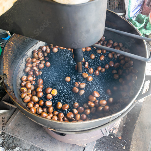 Chestnuts roasted in a large saucepan take photo by slowspeed shutter technic (Motion Background) photo