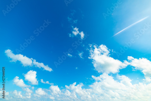 blue sky with white  soft clouds in the summertime