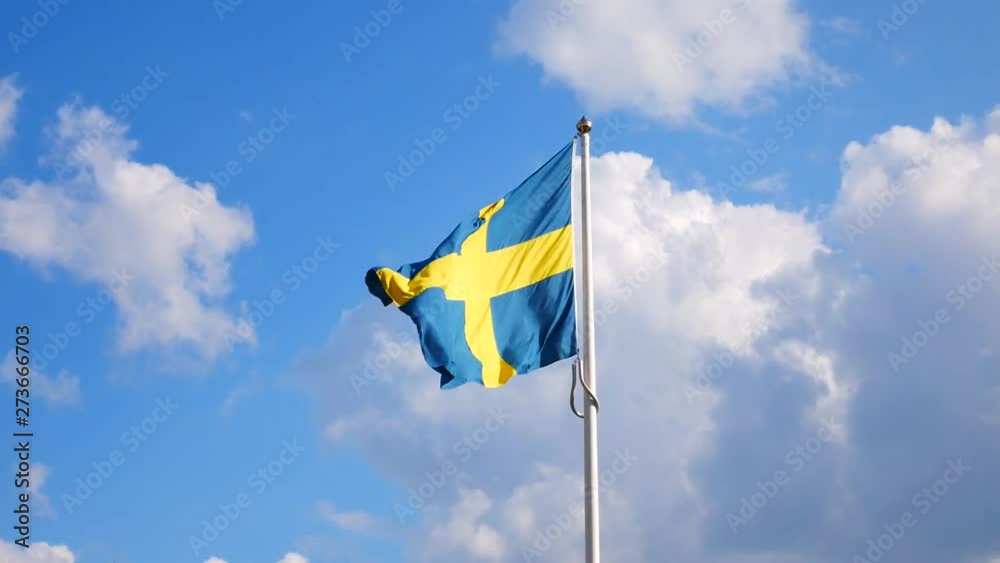 Swedish flag waving in the wind on a flagpole in Gothenburg, Sweden Swedish flag waving in the wind on a flagpole in Gothenburg, Sweden