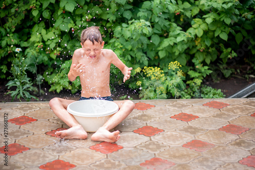young boy sitting on a bench in the park