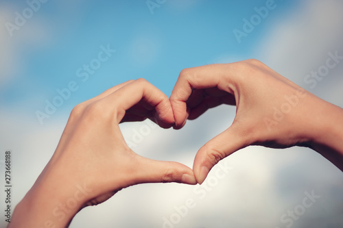 Hand on heart-shaped bokeh background blurred, natural tones vintage style. Show the world you love Love Family between two people.Let's Stay Together happy mother's day, © photosky99