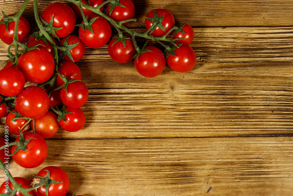 Fresh cherry tomatoes on a wooden table. Top view Fresh cherry tomatoes on a wooden table. Top view