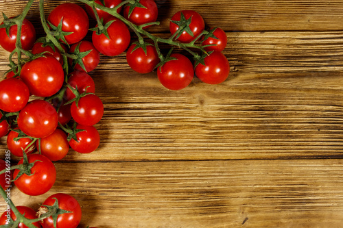 Fresh cherry tomatoes on a wooden table. Top view