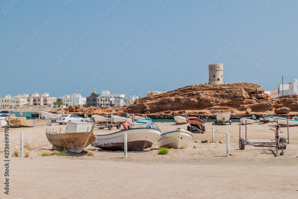 Fishing boats in Sur, Oman. Watchtower in Ayjah village in the background.
