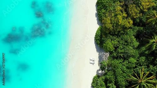 Wallpaper Mural Overhead footage of two isolated sun bathing beds on a tropical secluded beach in the Caribbean Sea. White sand and transparent water Torontodigital.ca