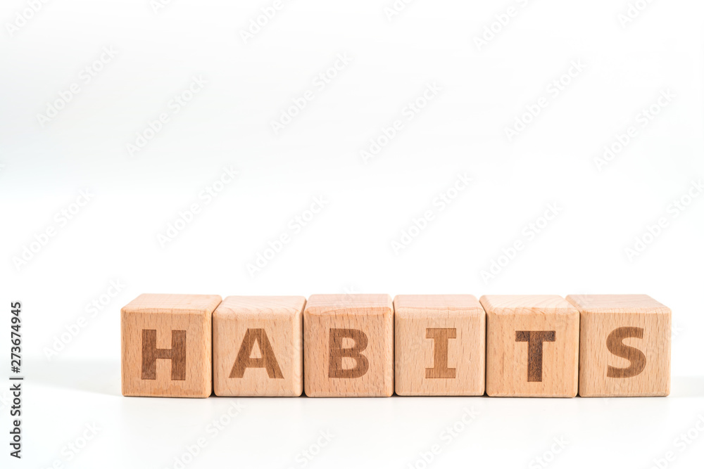 word HABITS on wood cube dices on white background. word HABITS on wood cube dices on white background.