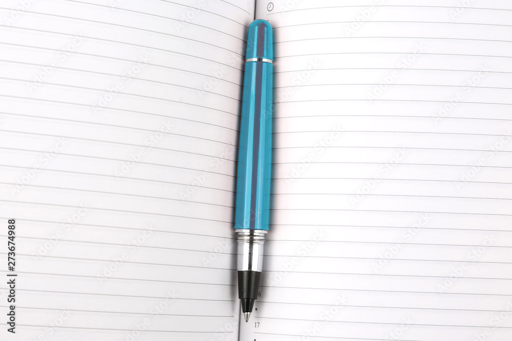pen lying on an open notebook.. subjects for business and education. pen lying on an open notebook.. subjects for business and education.
