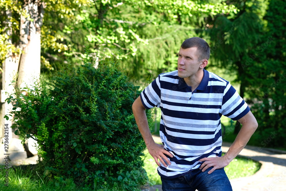 Young stylish man stay in a park. Lifestyle Outdoor street photo Young stylish man stay in a park. Lifestyle Outdoor street photo