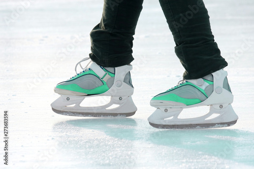 the legs of a man skating on the ice rink. sports, Hobbies and recreation of active people.