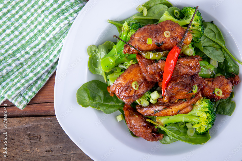spicy chicken thigh dish over spinach bed spicy chicken thigh dish over spinach bed